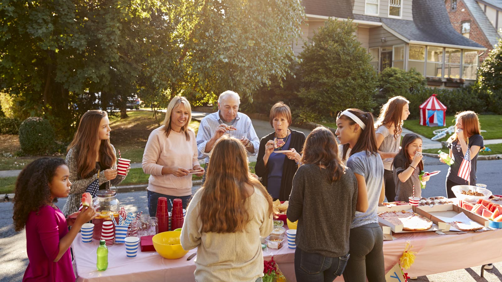 Gruppe Nachbarn jeden Alters feiert Straßenfest
