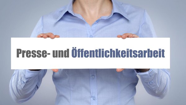 Frau hält Schild mit der Aufschrift Presse- und Öffentlichkeitsarbeit